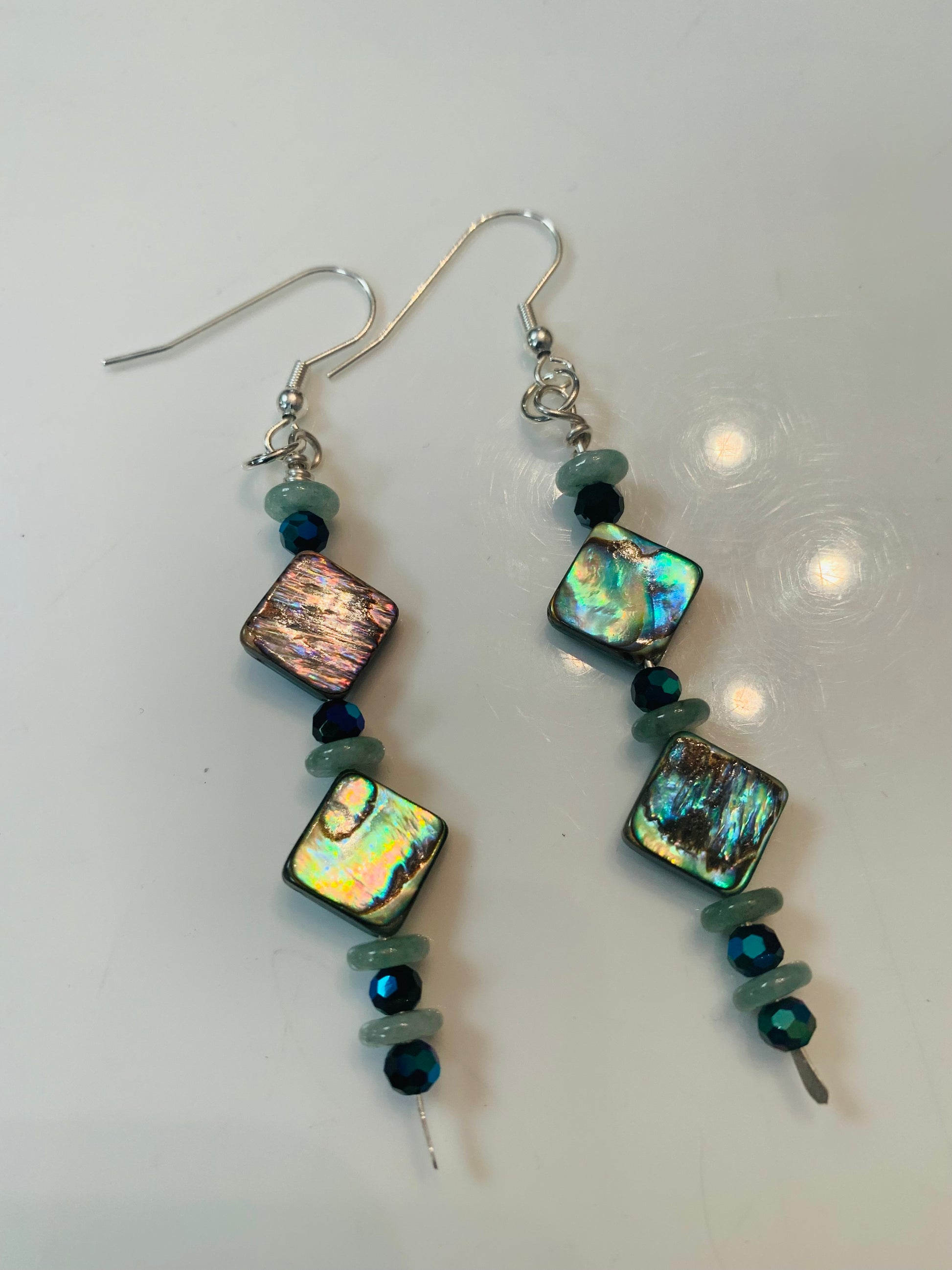 Abalone shell earrings with blue accents