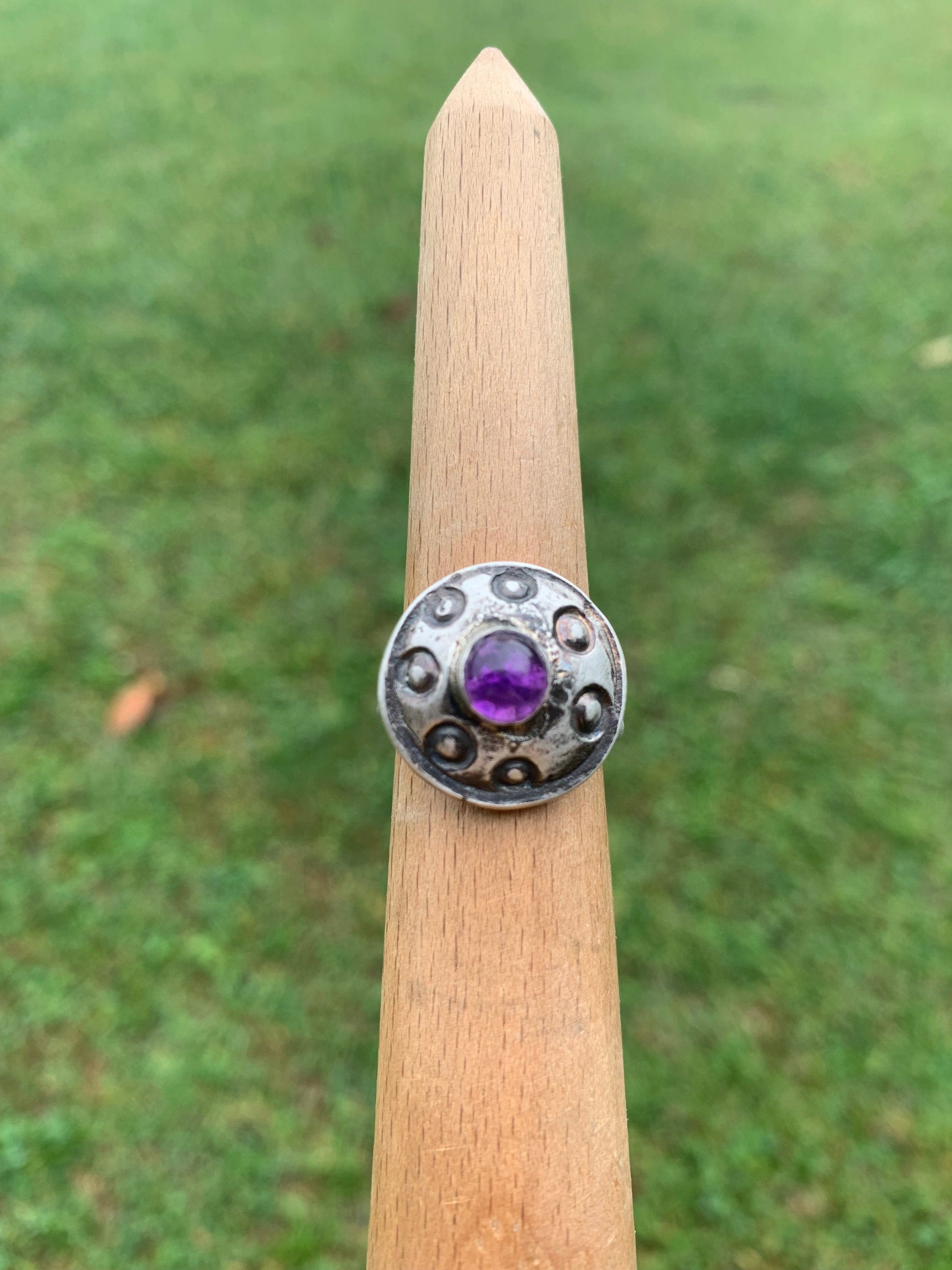 Amethyst ring, ButtonAmethyst6, on wooden stand