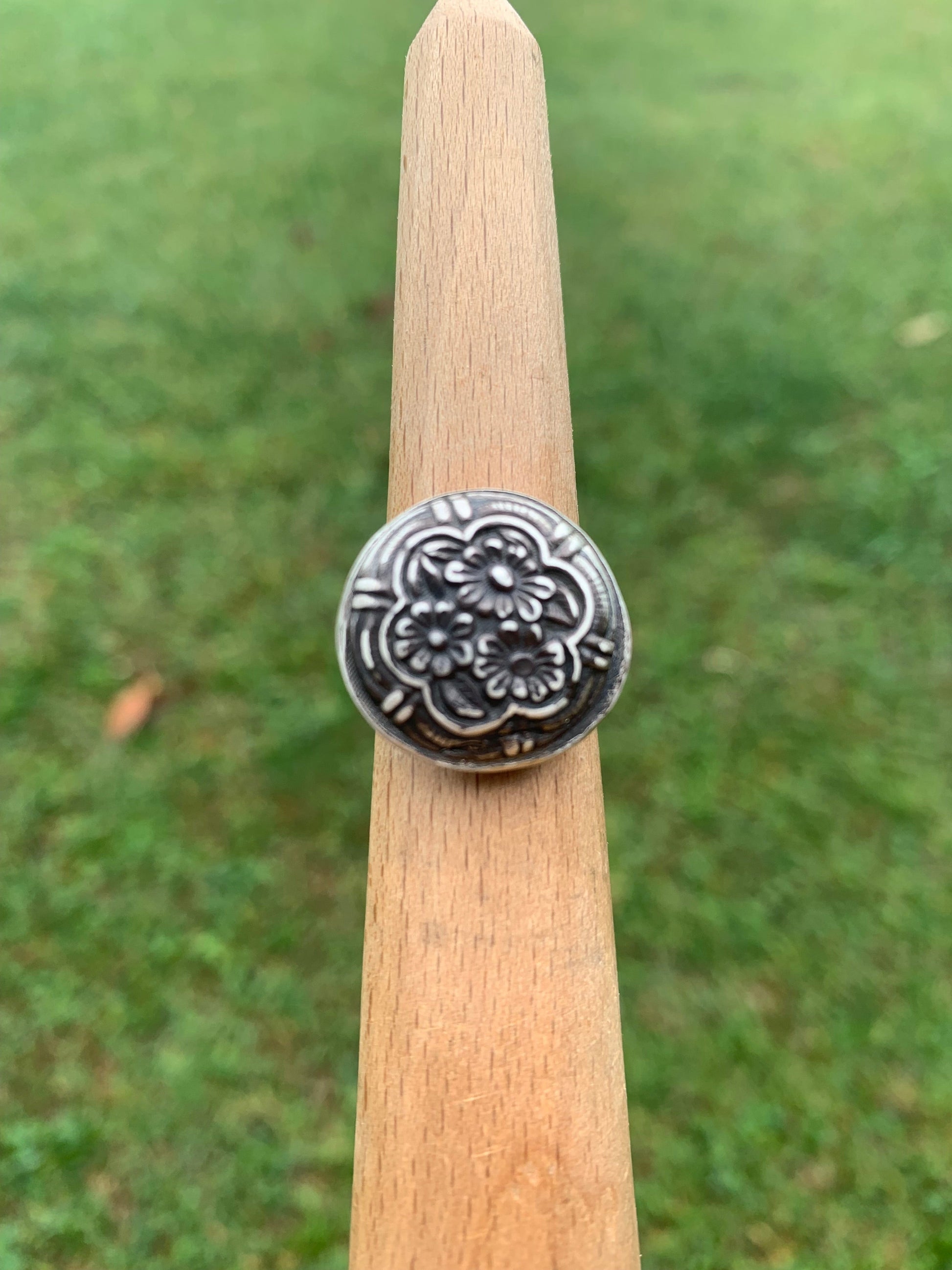 Button flower ring on display