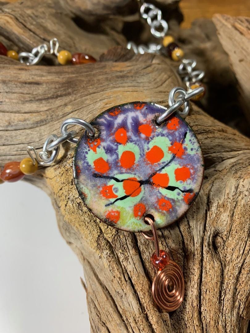 Colorful diversity necklace on driftwood.