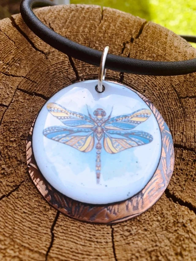 Dragonfly pendant necklace on wood