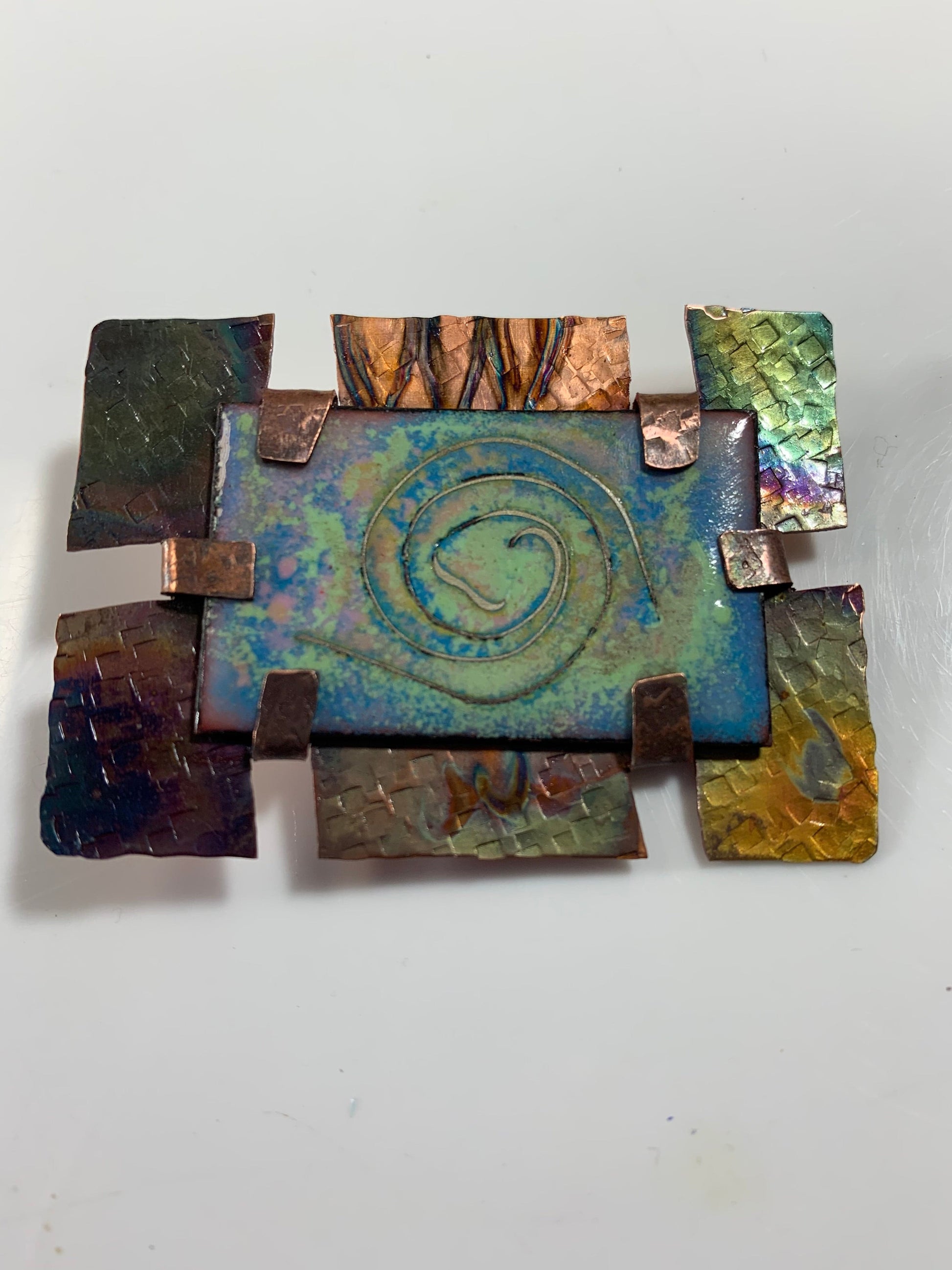 Abstract metal art with spiral design.