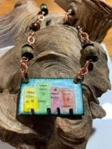 Pueblo skyline necklace with colorful buildings and copper chain.