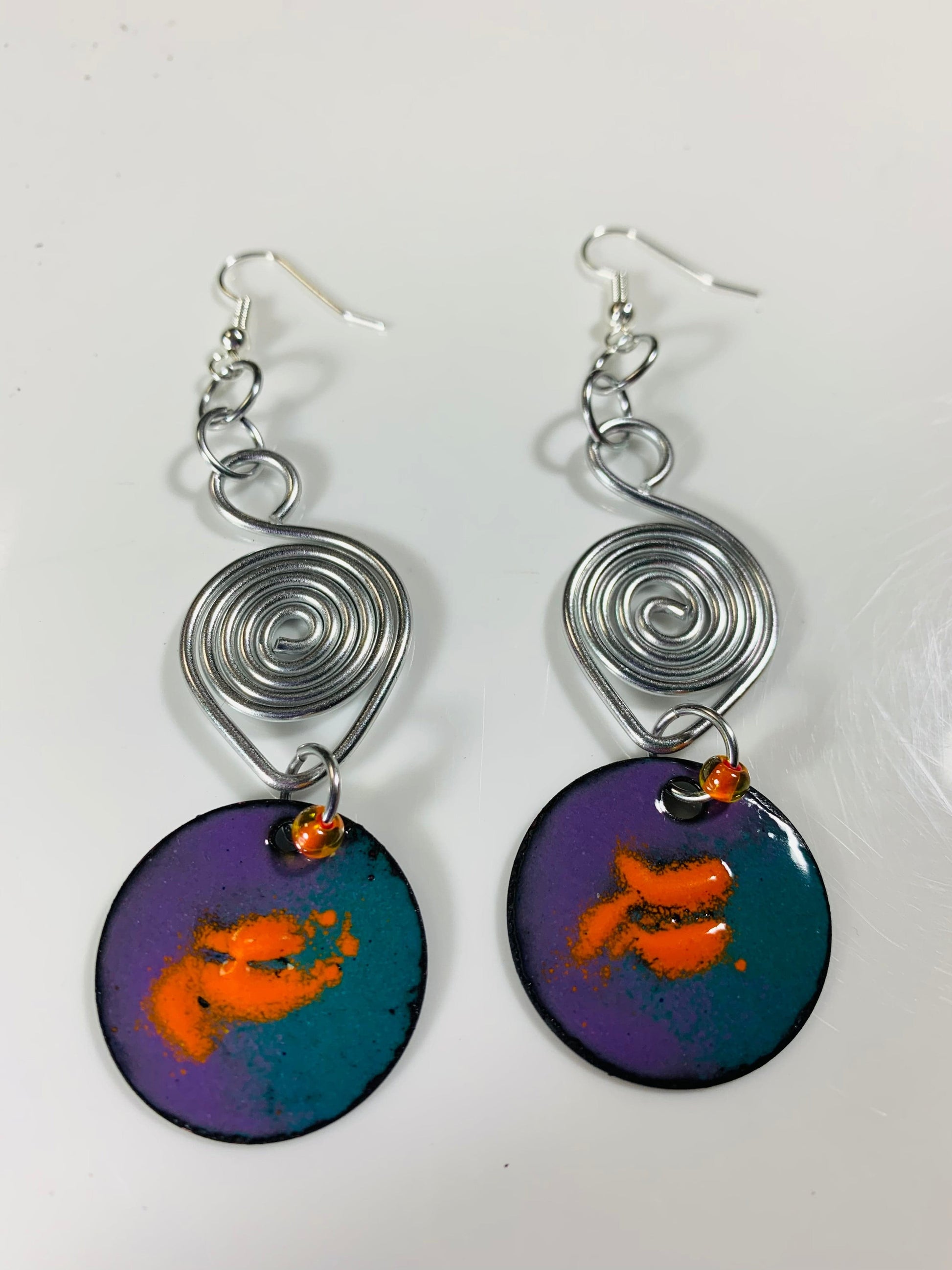 Splash of Orange earrings with teal and purple enamel.