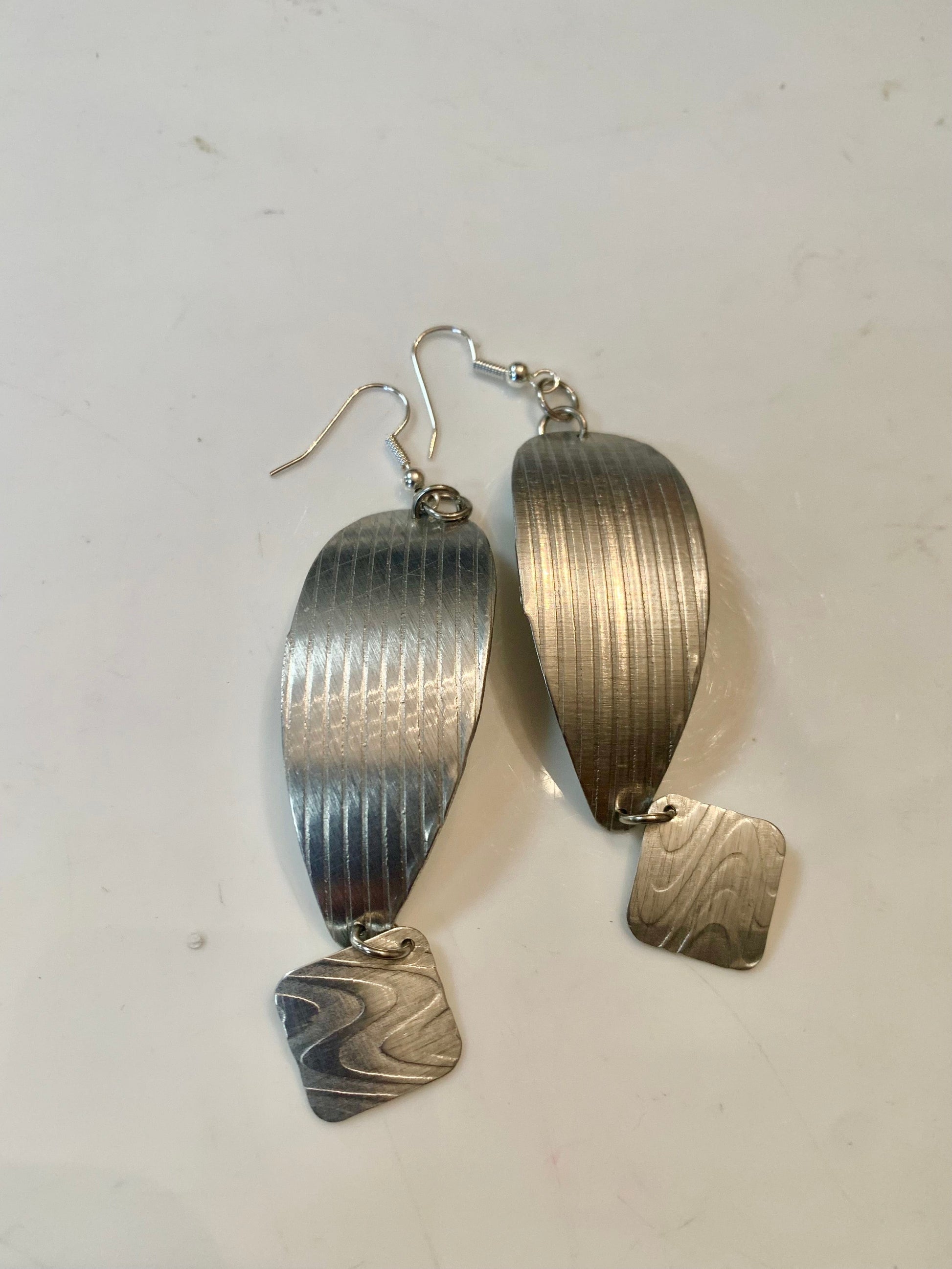 Teardrop earrings with textured silver design