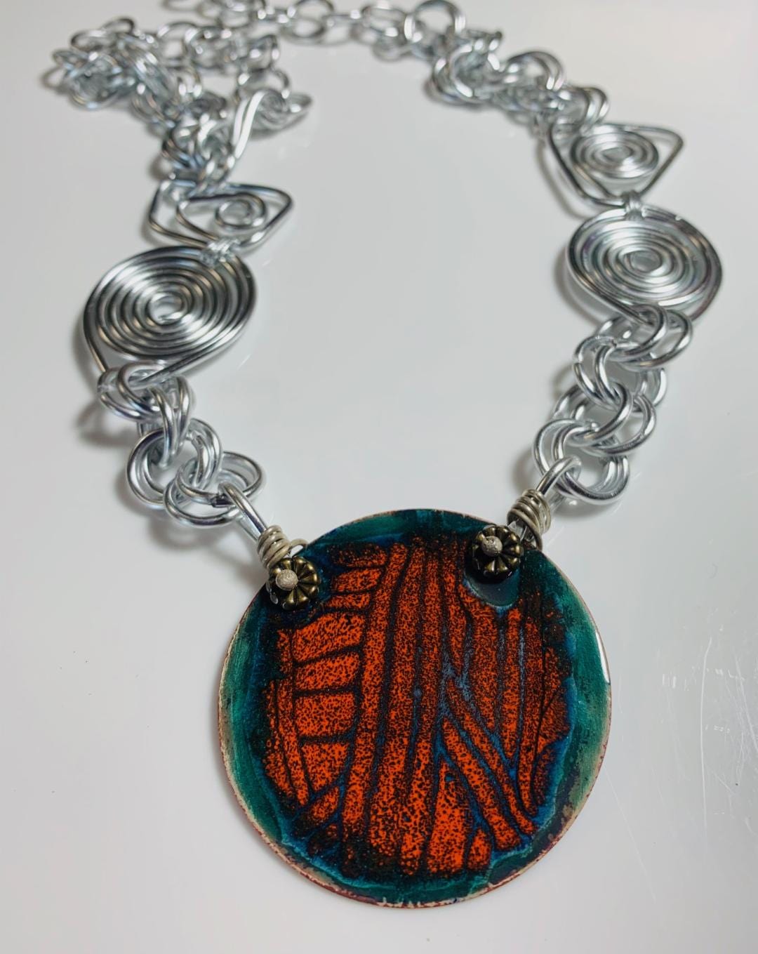 Handmade wire and enamel pendant necklace.