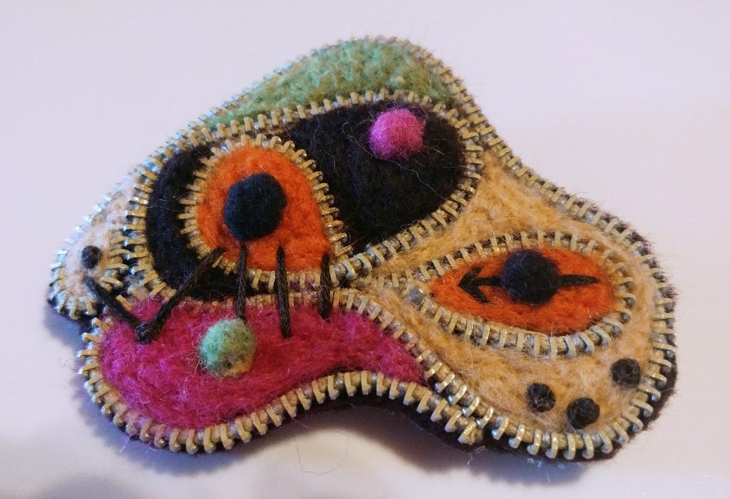 WhatsUp felt art brooch with abstract design.
