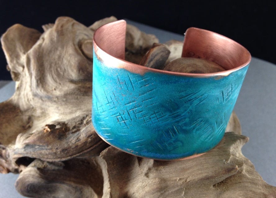 Wide patina cuff bracelet on driftwood