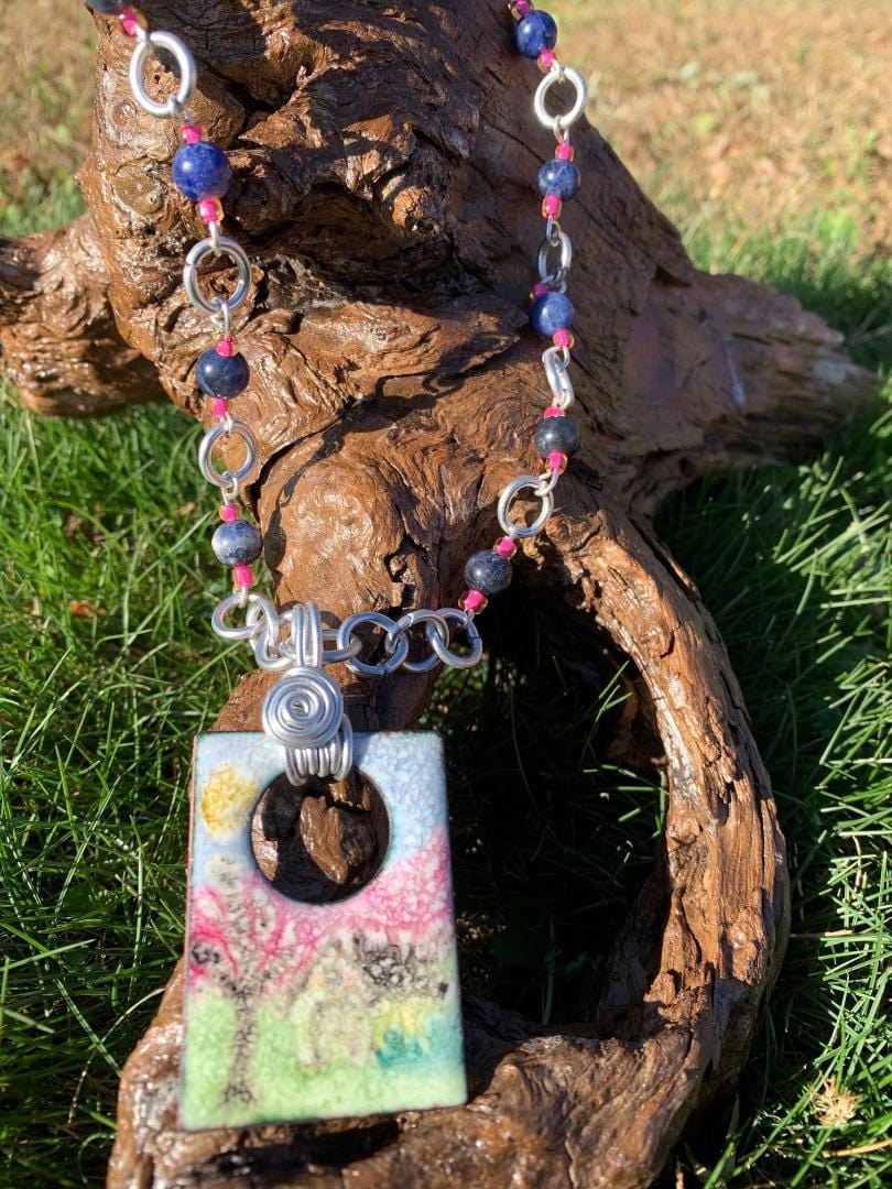 Ghostfarm necklace with pendant on driftwood.