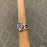 Silver buckle ring on wooden form