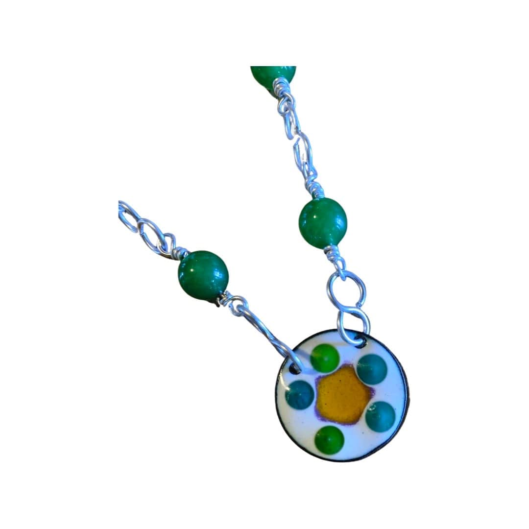 Green sphere necklace with a white and yellow pendant.