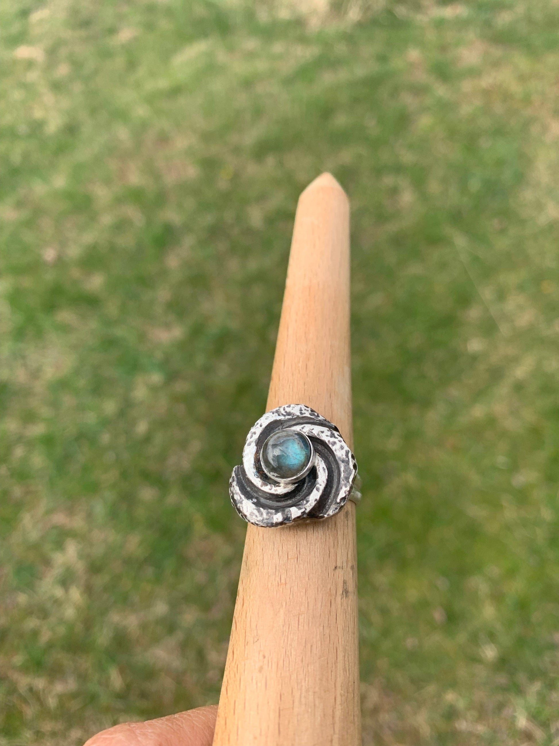 Spiral Labradorite ring on wooden stand