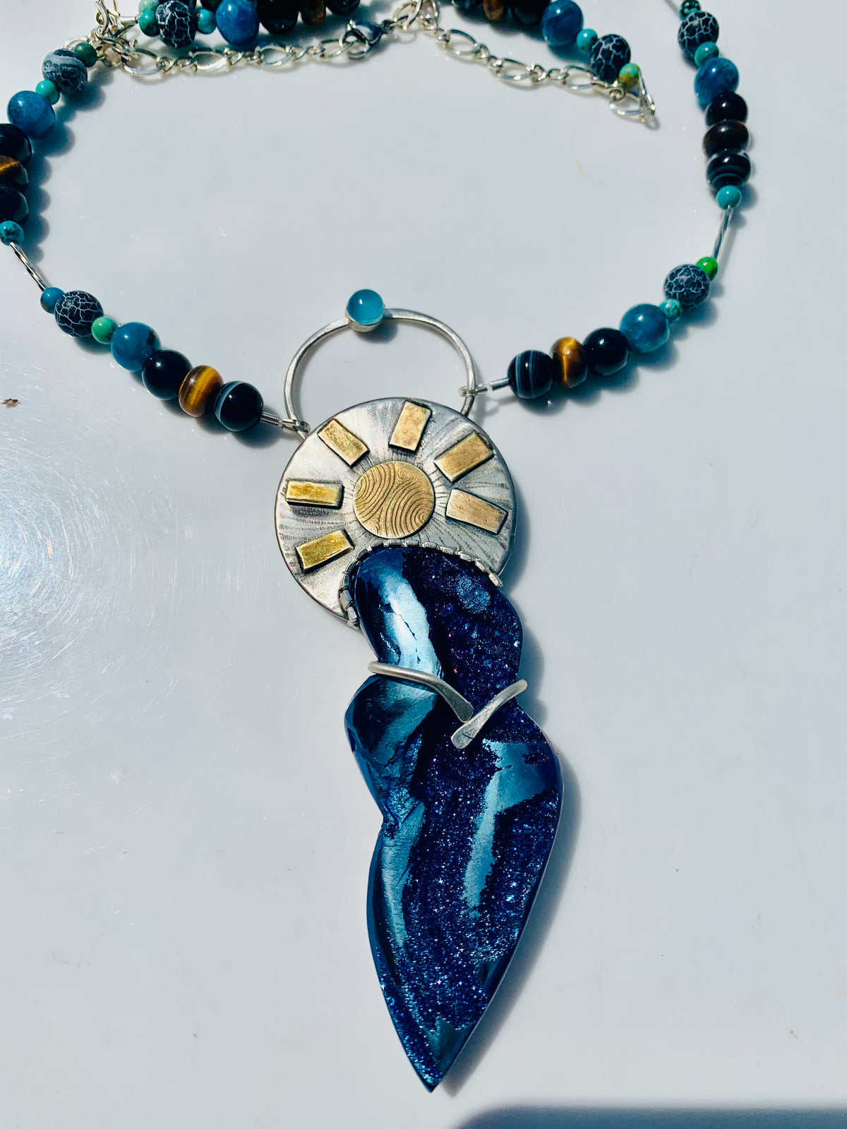 Close-up of Goddess pendant with Titanium Coquina Blue Chalcedony sterling silver and 14K gold-plated details