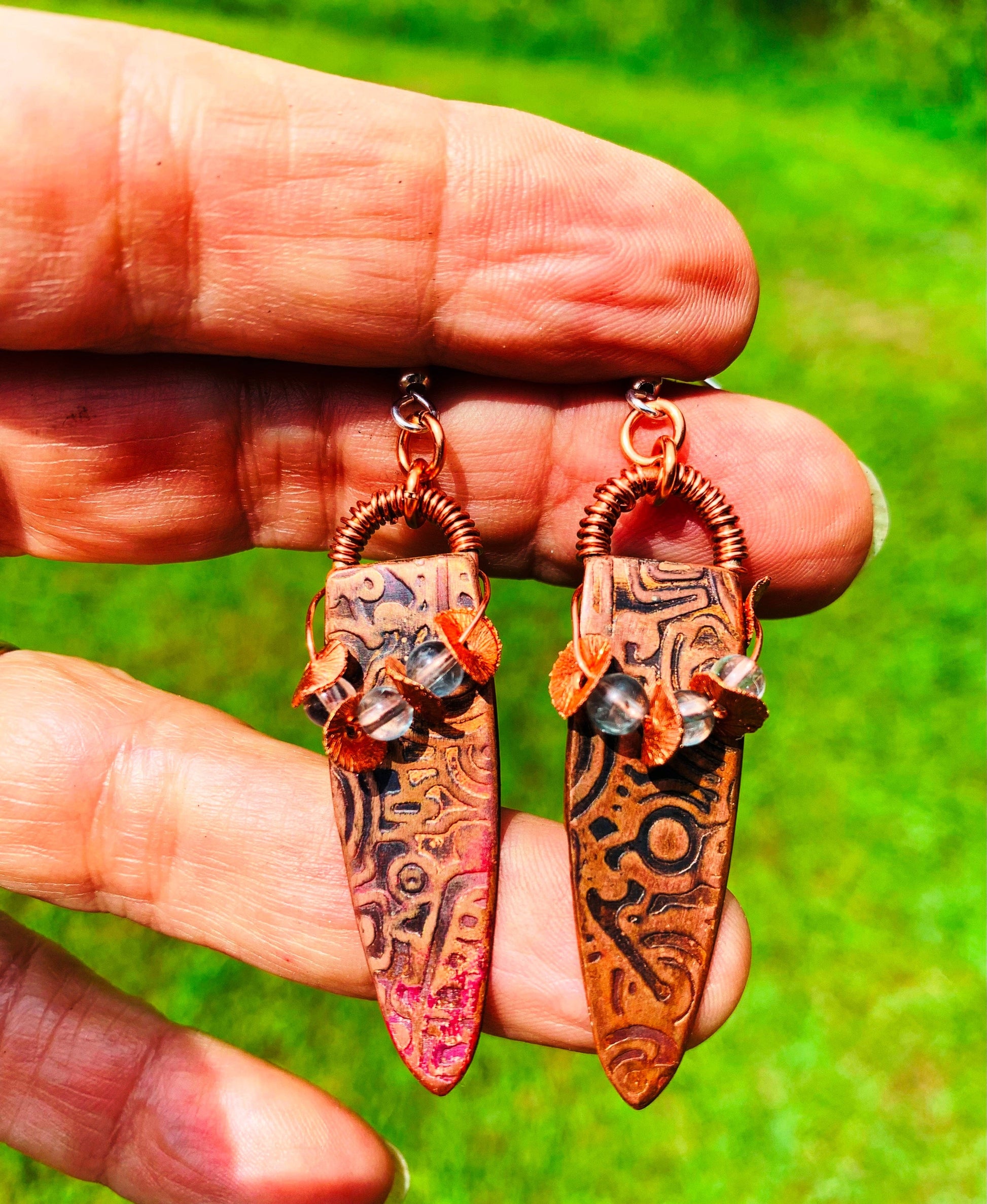 Apatite copper flake earrings held in hand