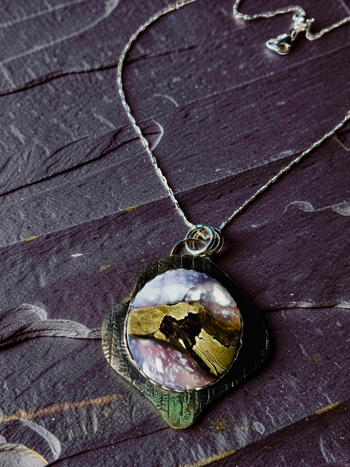At the Edge of Forever purple scenic chalcedony pendant in hand-textured sterling silver by Christine Keller, on an adjustable silver chain.