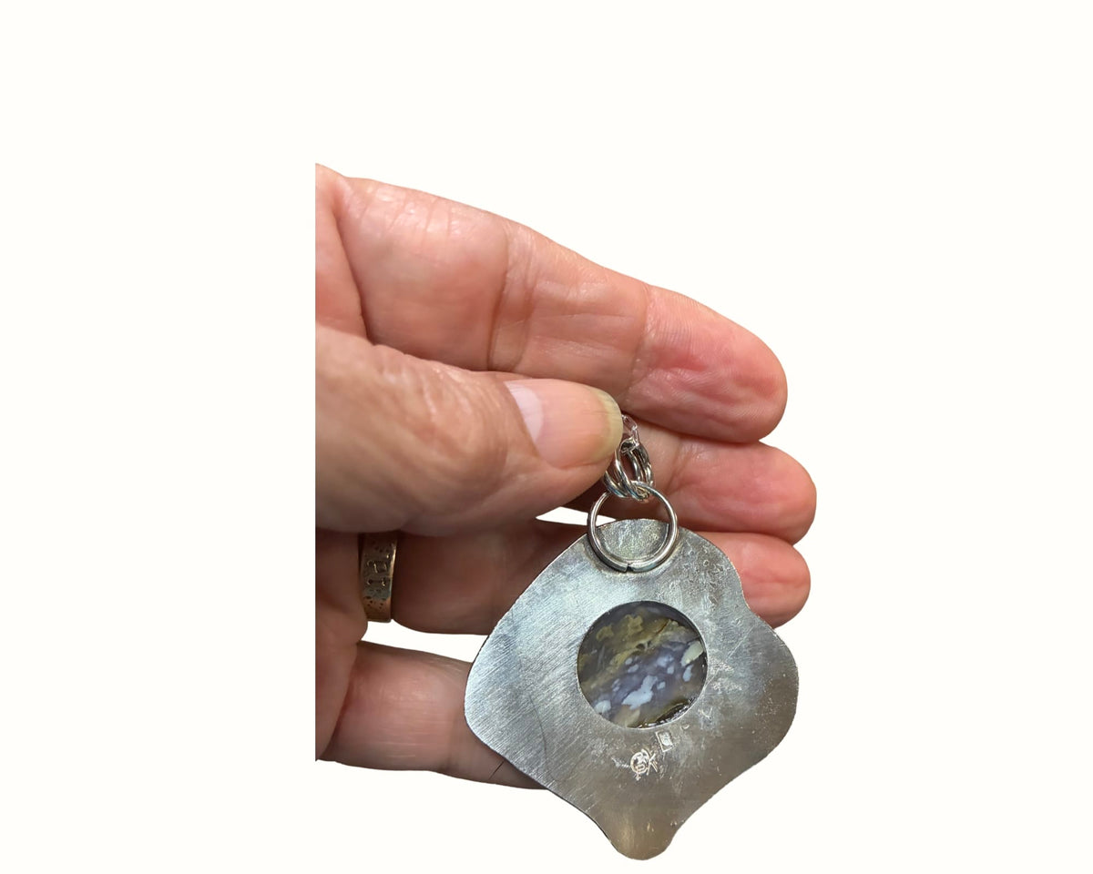 Reverse of At the Edge of Forever sterling silver pendant showing open-back purple chalcedony gemstone setting and Christine Keller artist hallmark.
