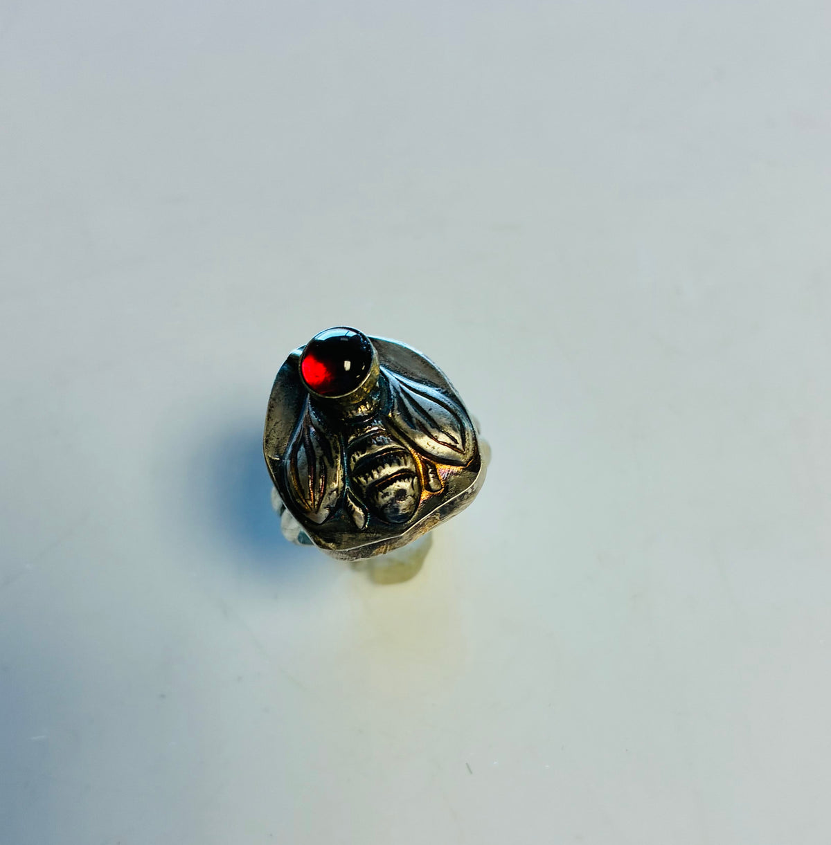Heart of the Hive size 9 sterling silver bee ring with natural red garnet handcrafted by Christine Keller of Chrizart Creations