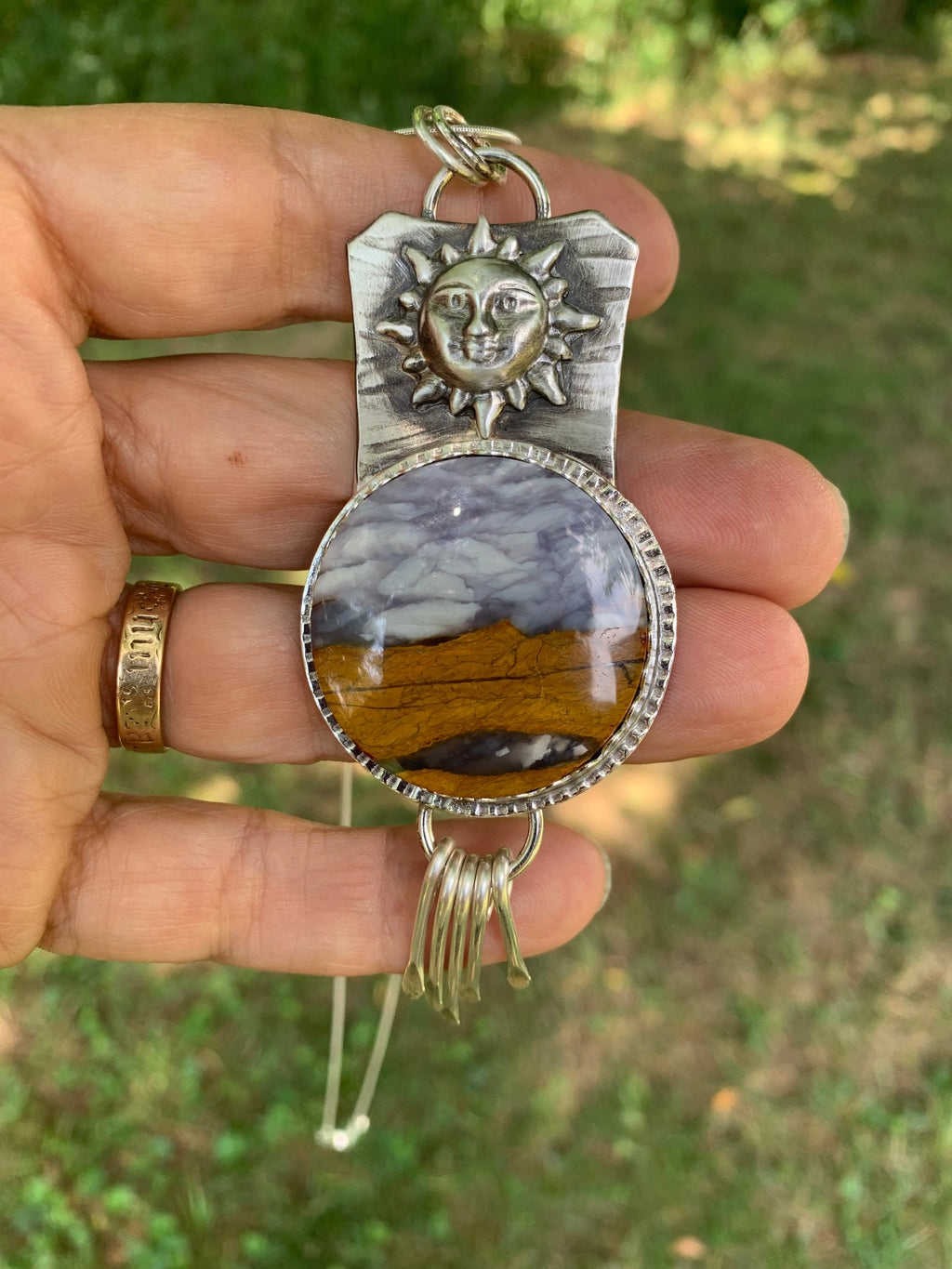 Close-up of Prairie Dawn Polychrome Jasper art pendant showing natural prairie landscape and silver sun