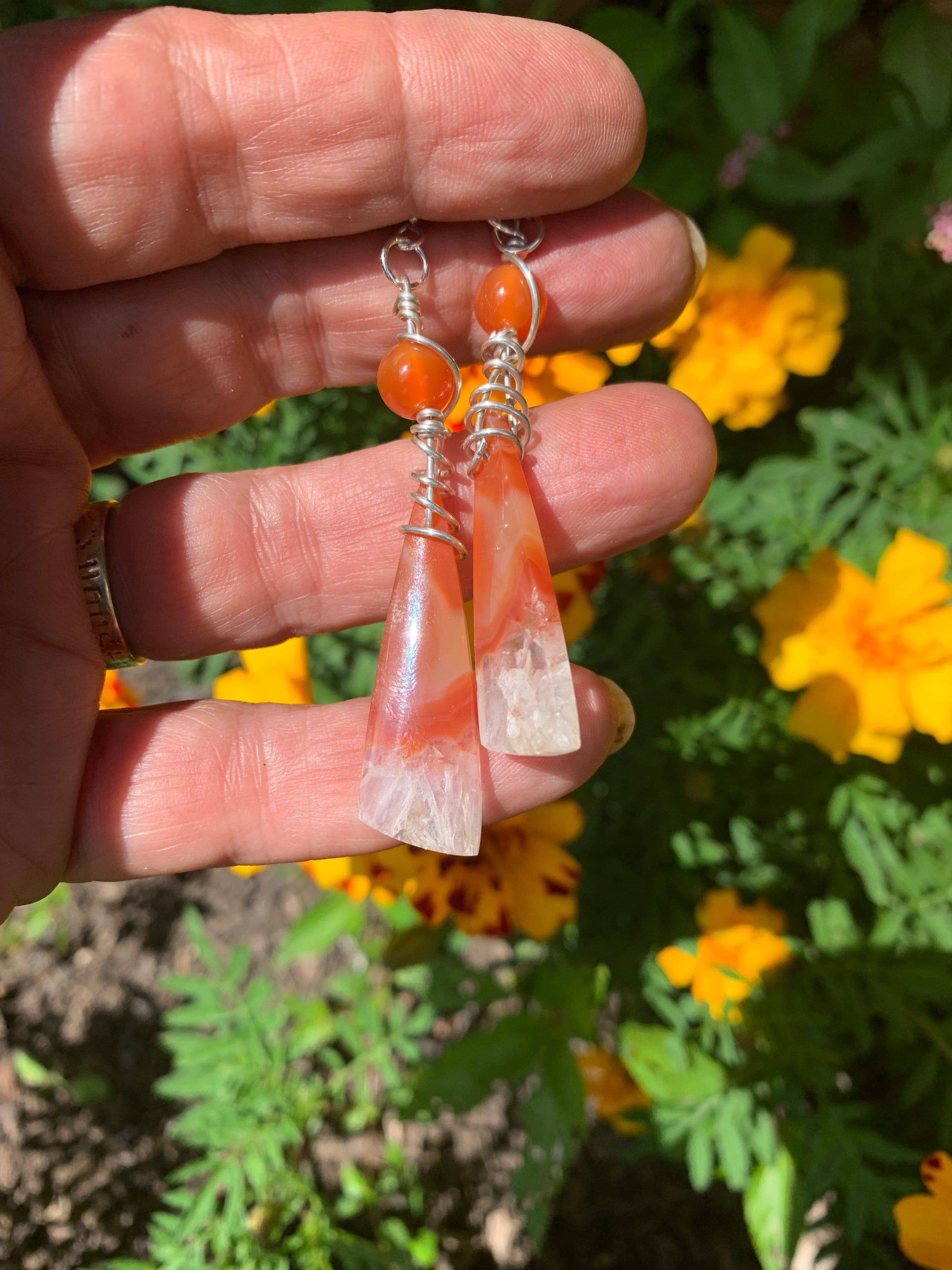 Carnelian Ice Earrings held in hand