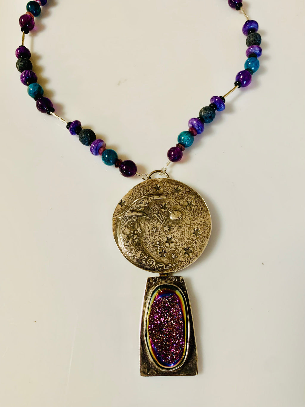 Necklace with a decorative pendant on a plain background