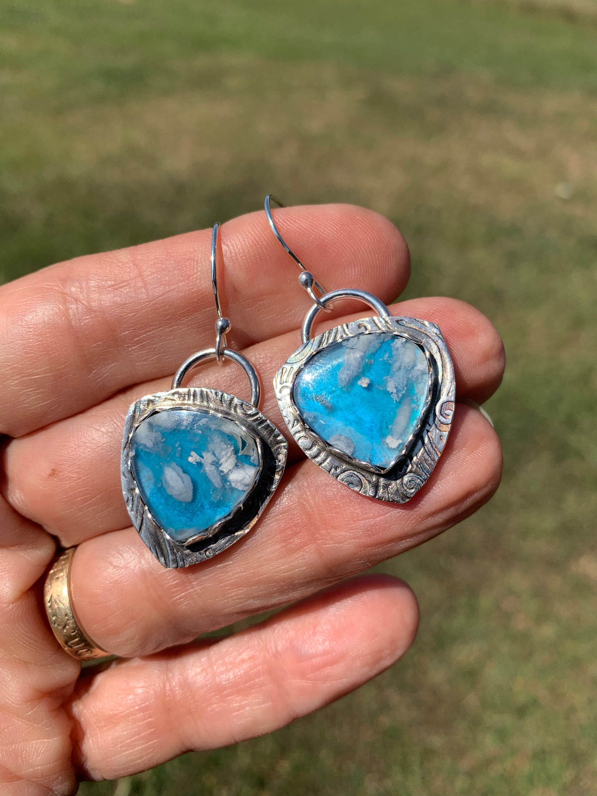 DreamClouds heart earrings in hand