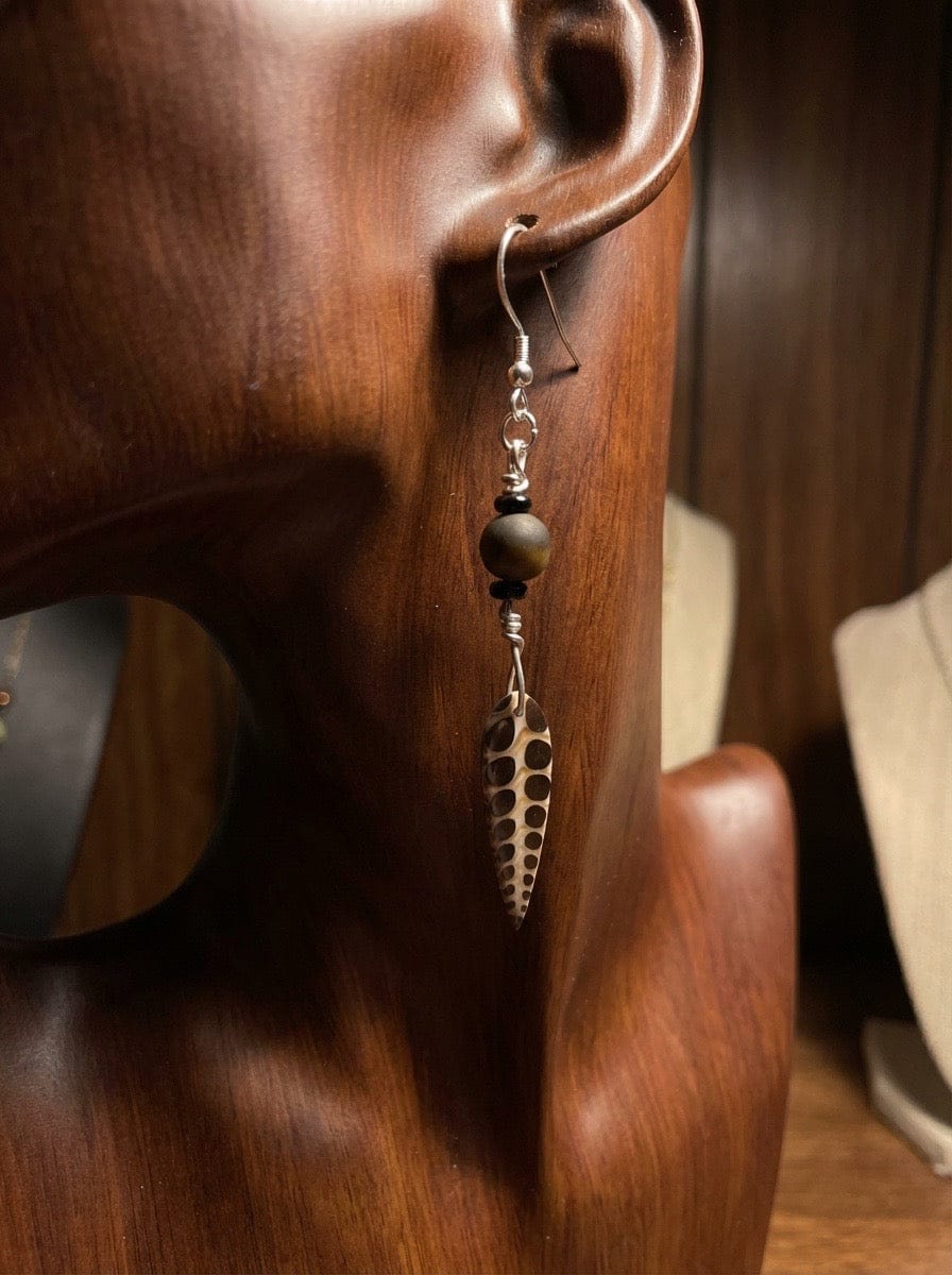 Faux Fossil and Tiger Earrings on a wooden head display