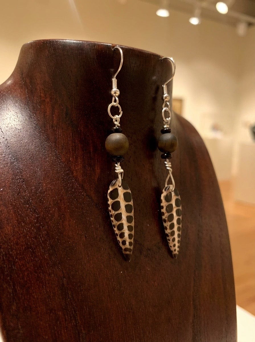 faux fossil and tiger eye earrings on a wooden dispaly