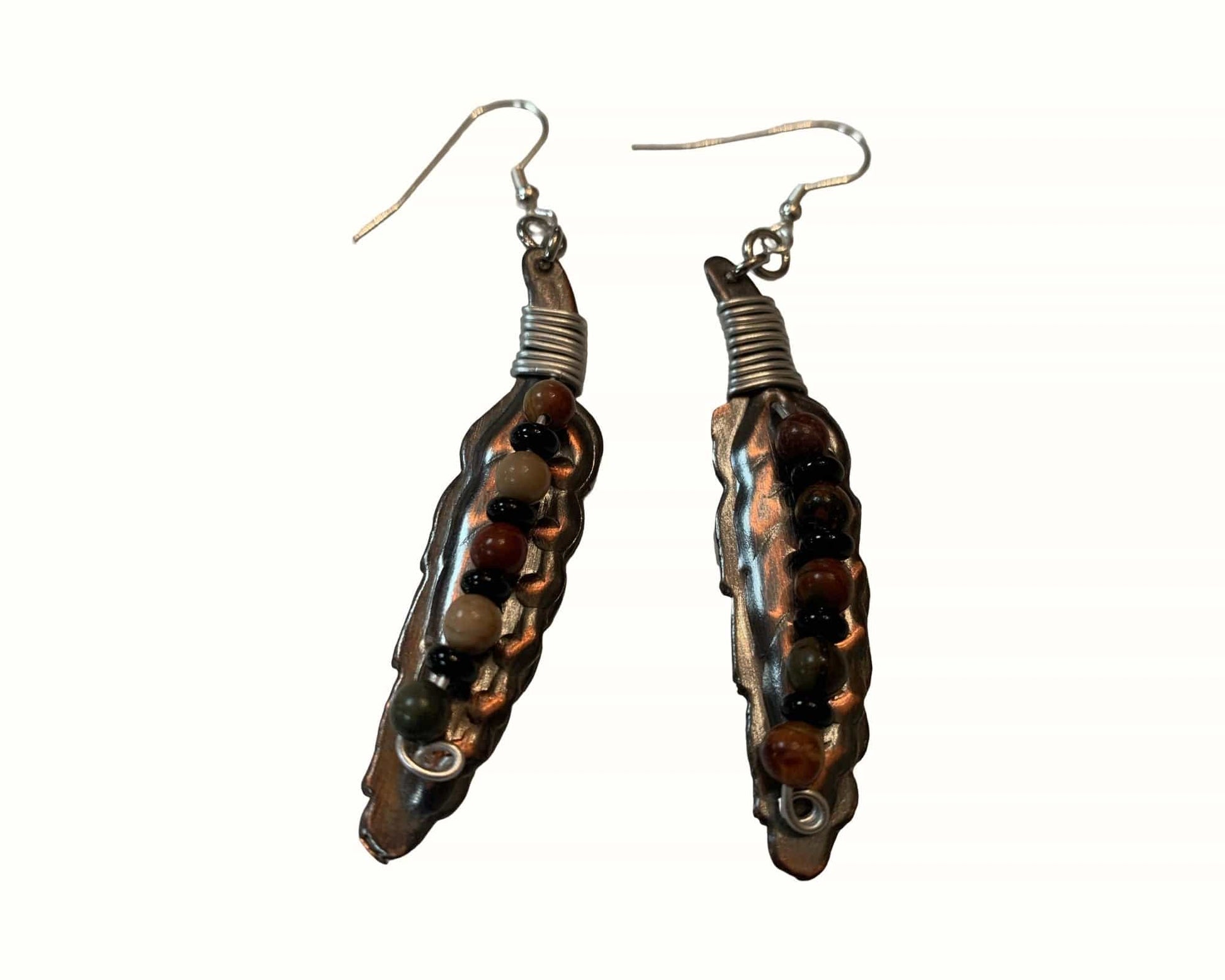 Pair of feather-shaped earrings on a white background