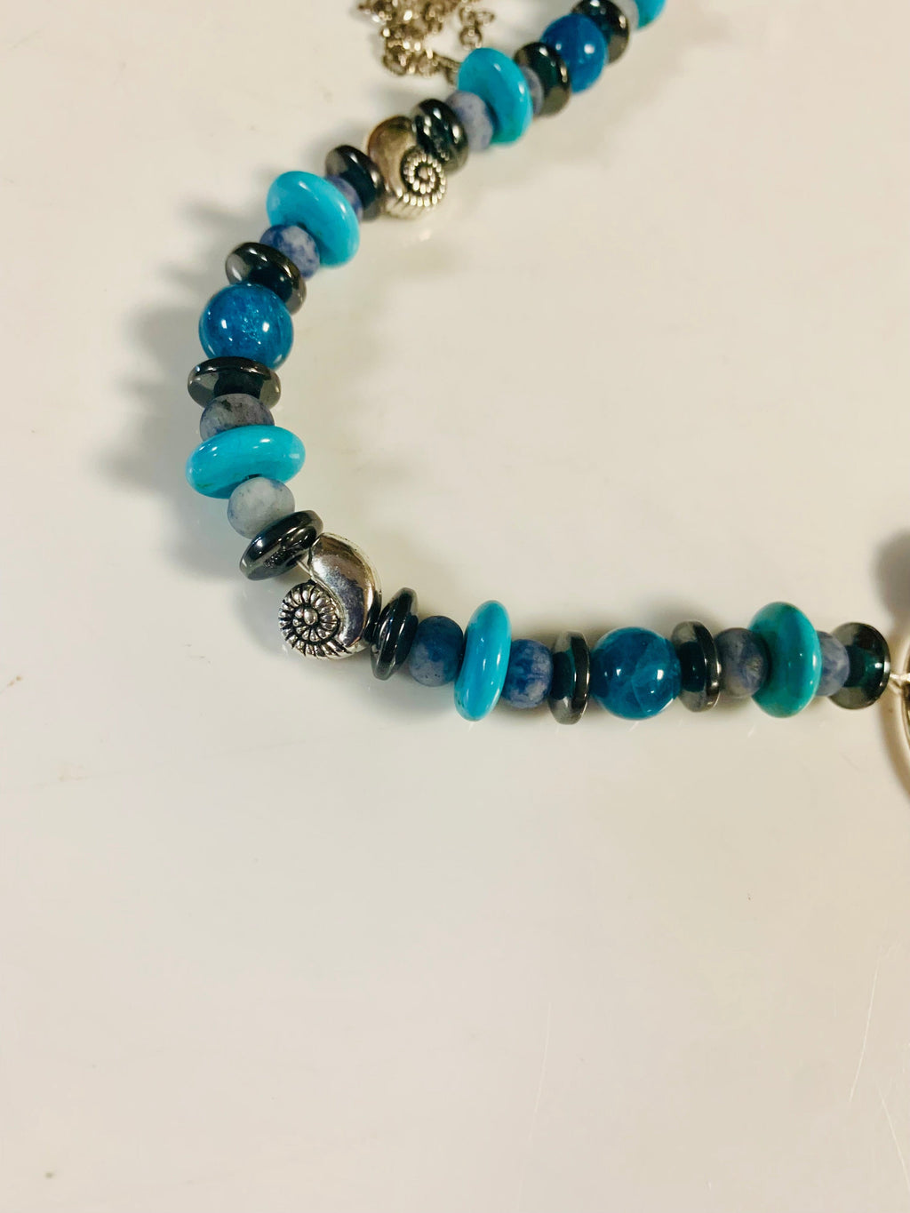 Goddess of the Sea beaded necklace with turquoise and dark blue beads.