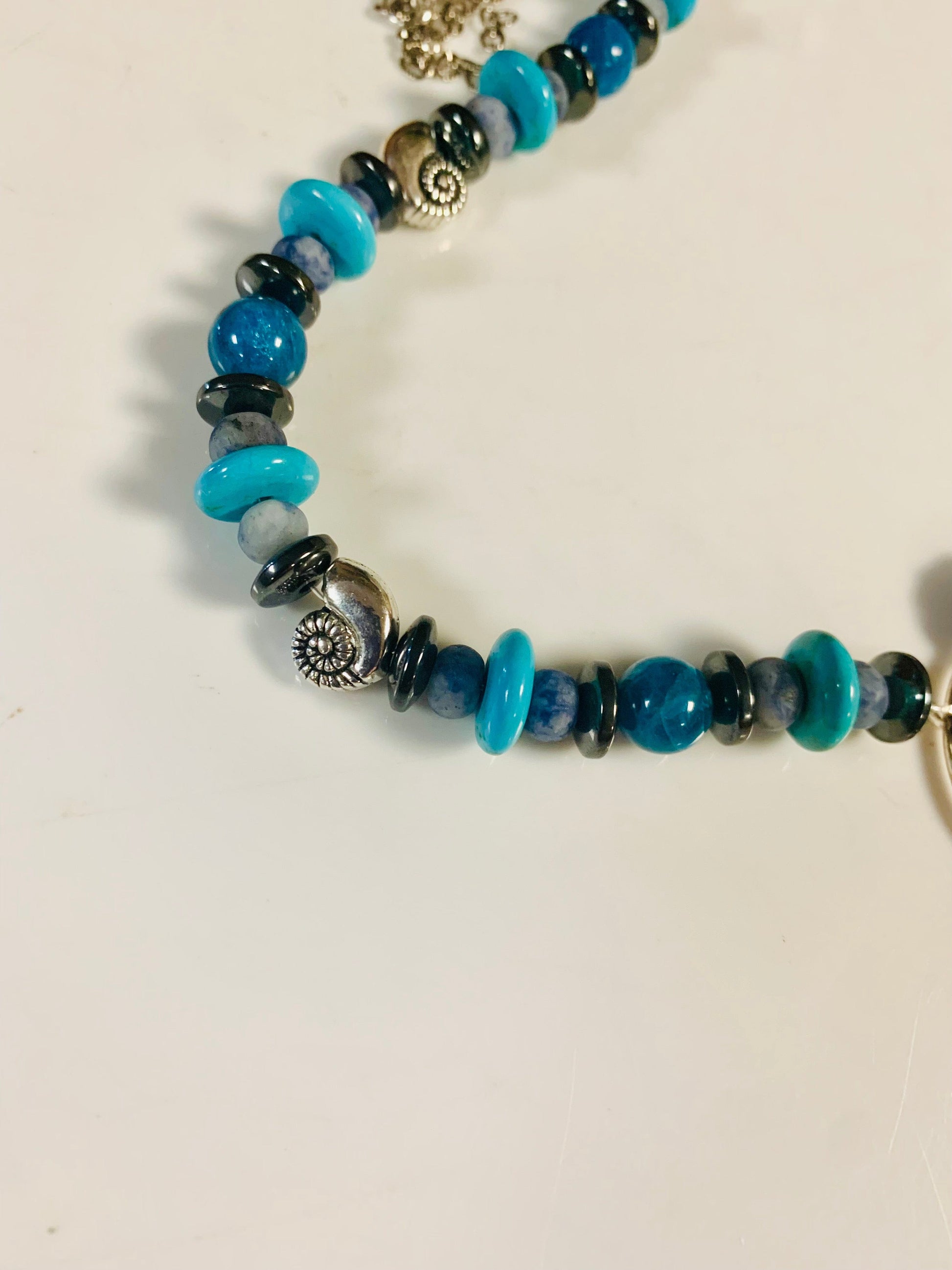 Goddess of the Sea beaded necklace with turquoise and dark blue beads.