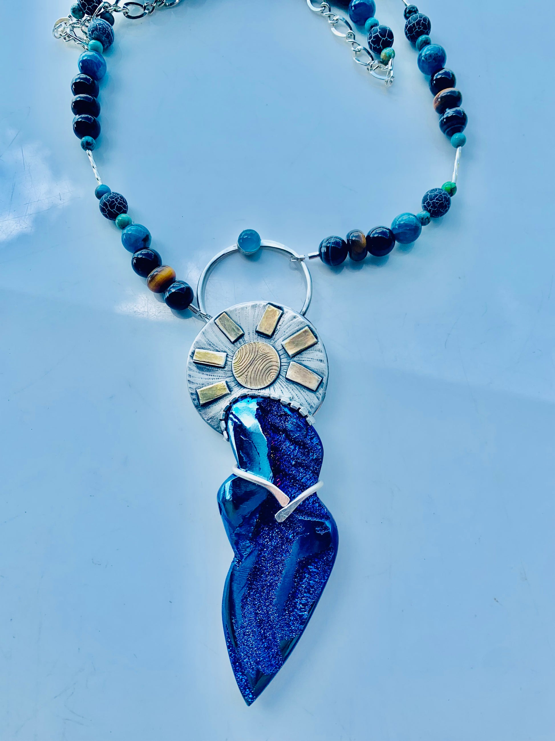 Goddess Pendant necklace with blue gemstone and sunburst design