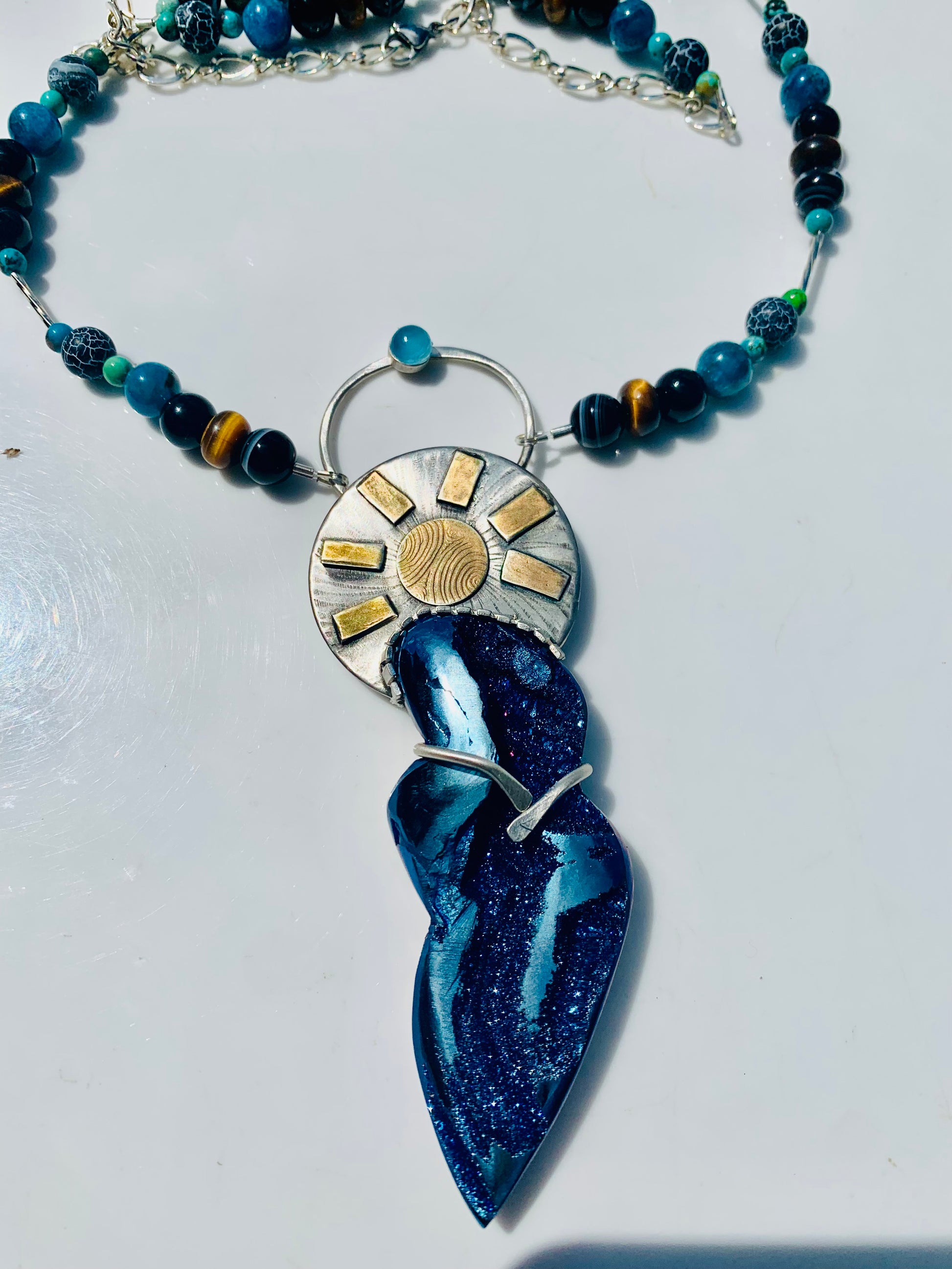 Goddess Pendant necklace with blue stone, turquoise beads, and gold accents.