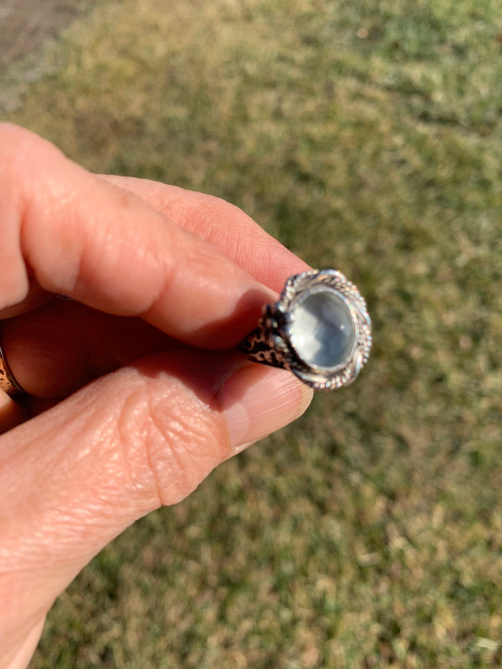 Green Amethyst ring held in hand