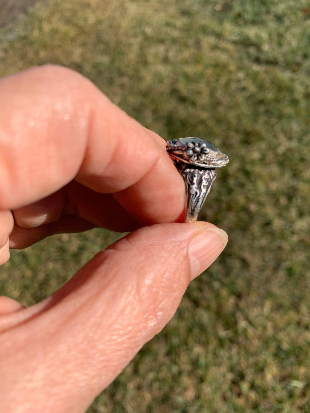 Green Amethyst ring held in hand