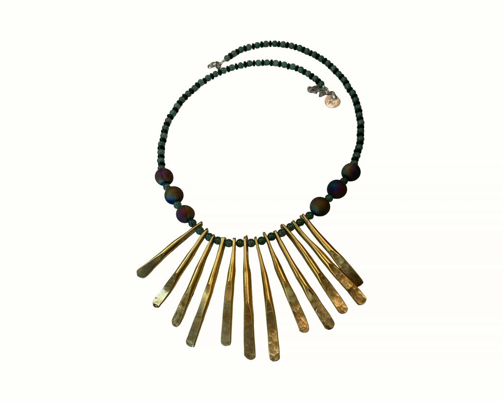 Necklace with stone beads and  brass fringe on a white background