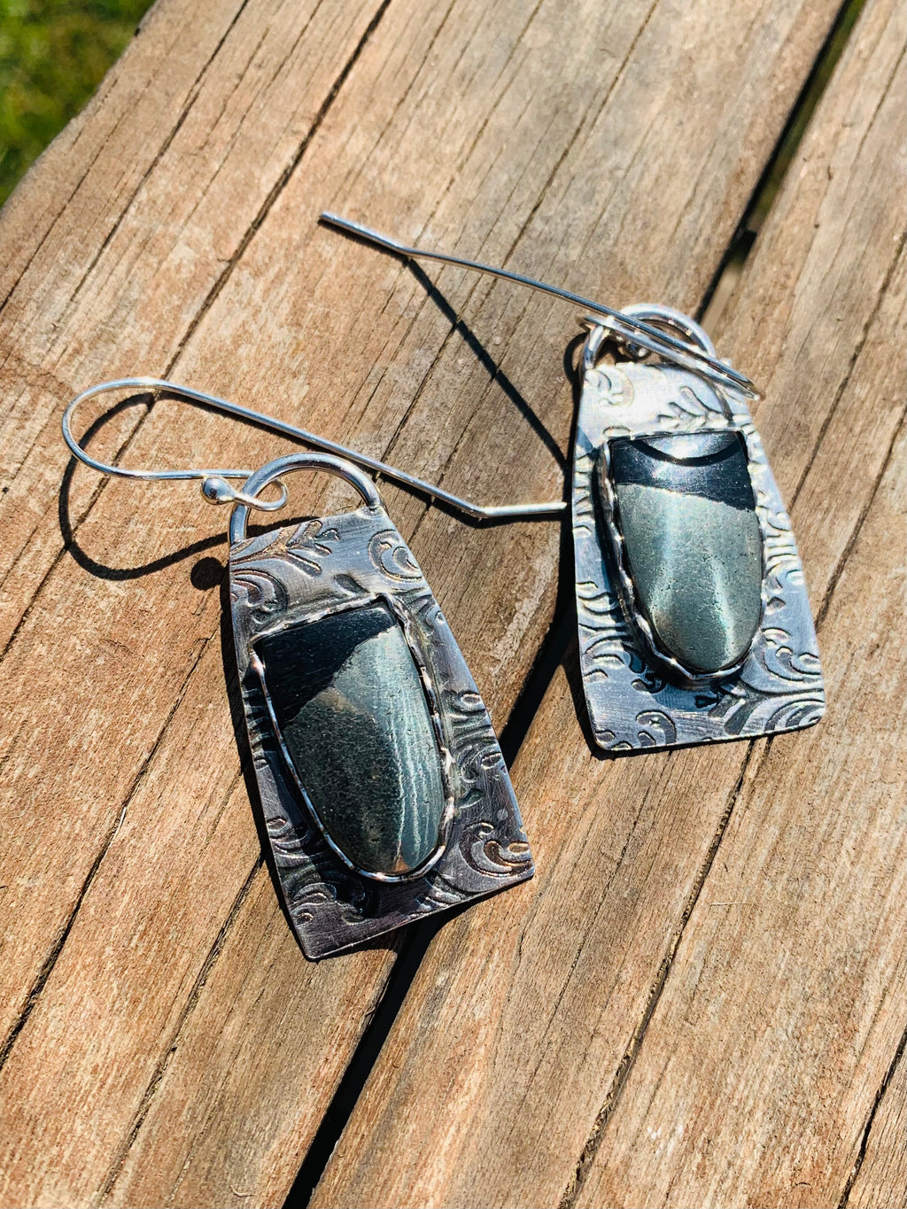 Hematite earrings on wood surface