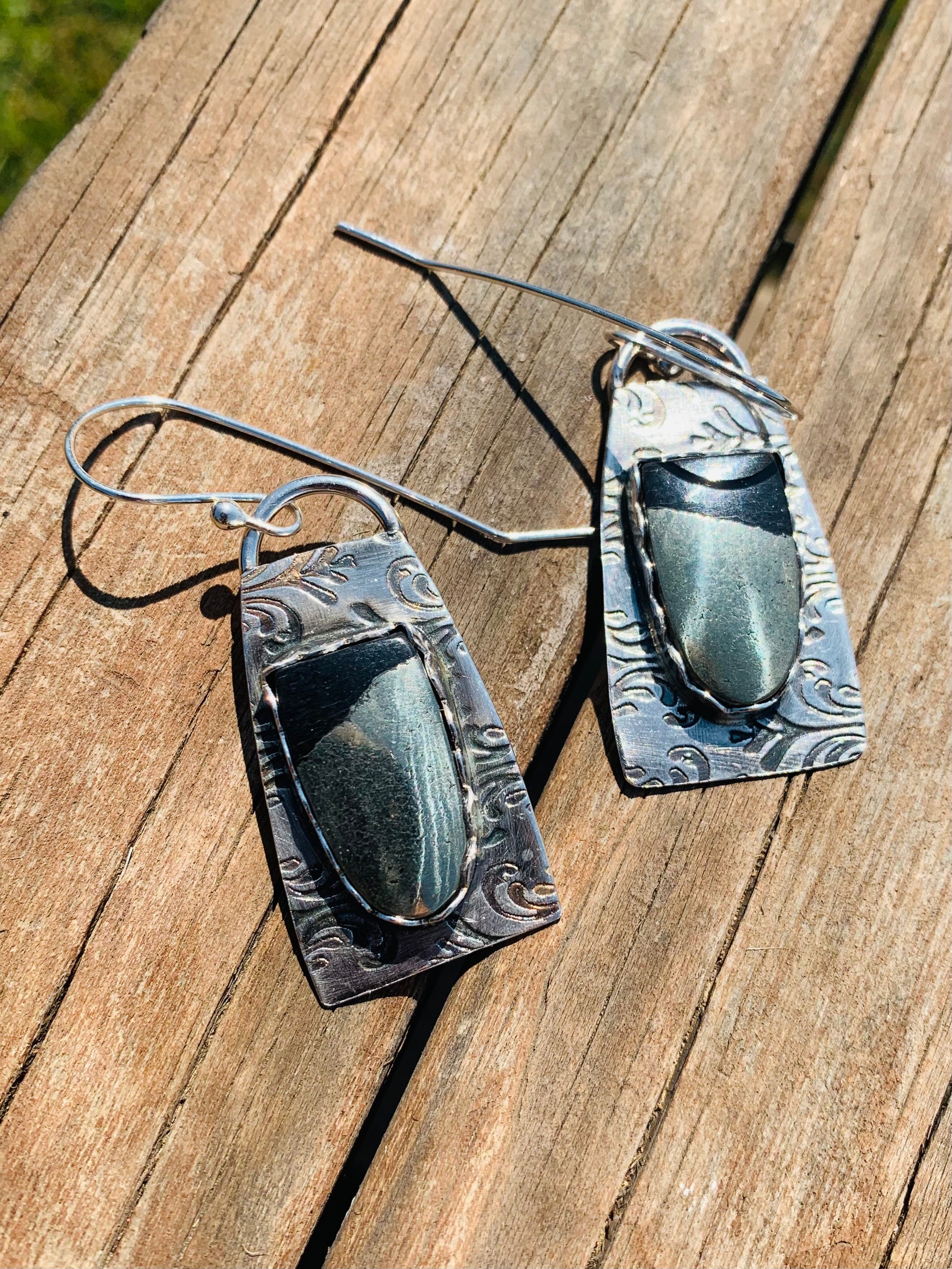 Hematite earrings on wood surface