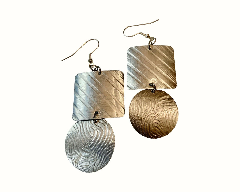 Pair of earrings with geometric designs on a white background