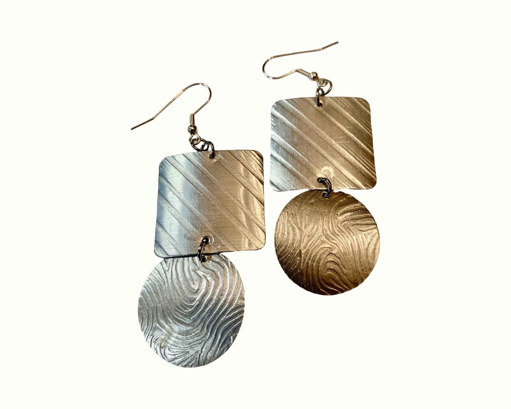 Pair of earrings with geometric designs on a white background