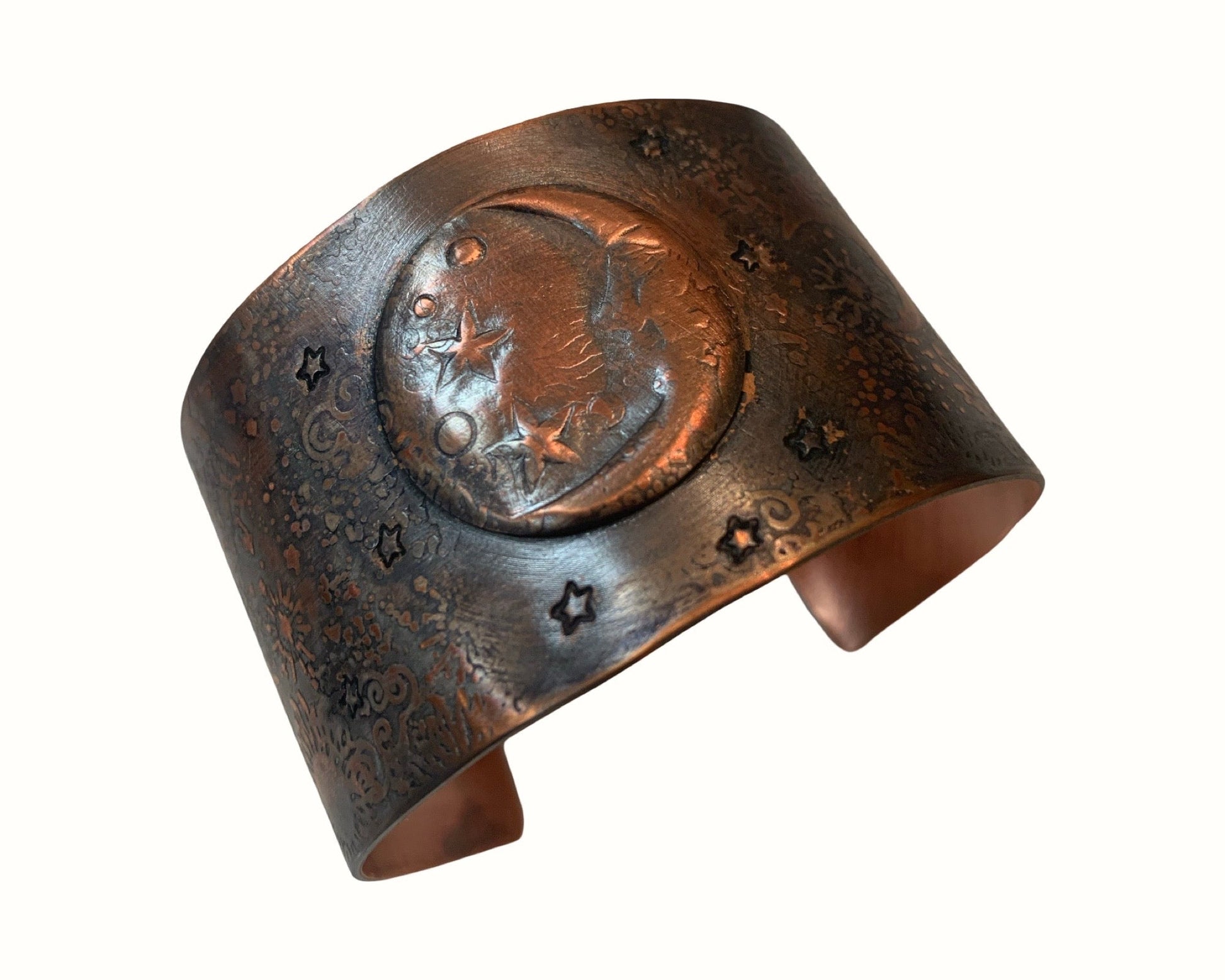 Copper cuff bracelet with Moon and star designs on a white background