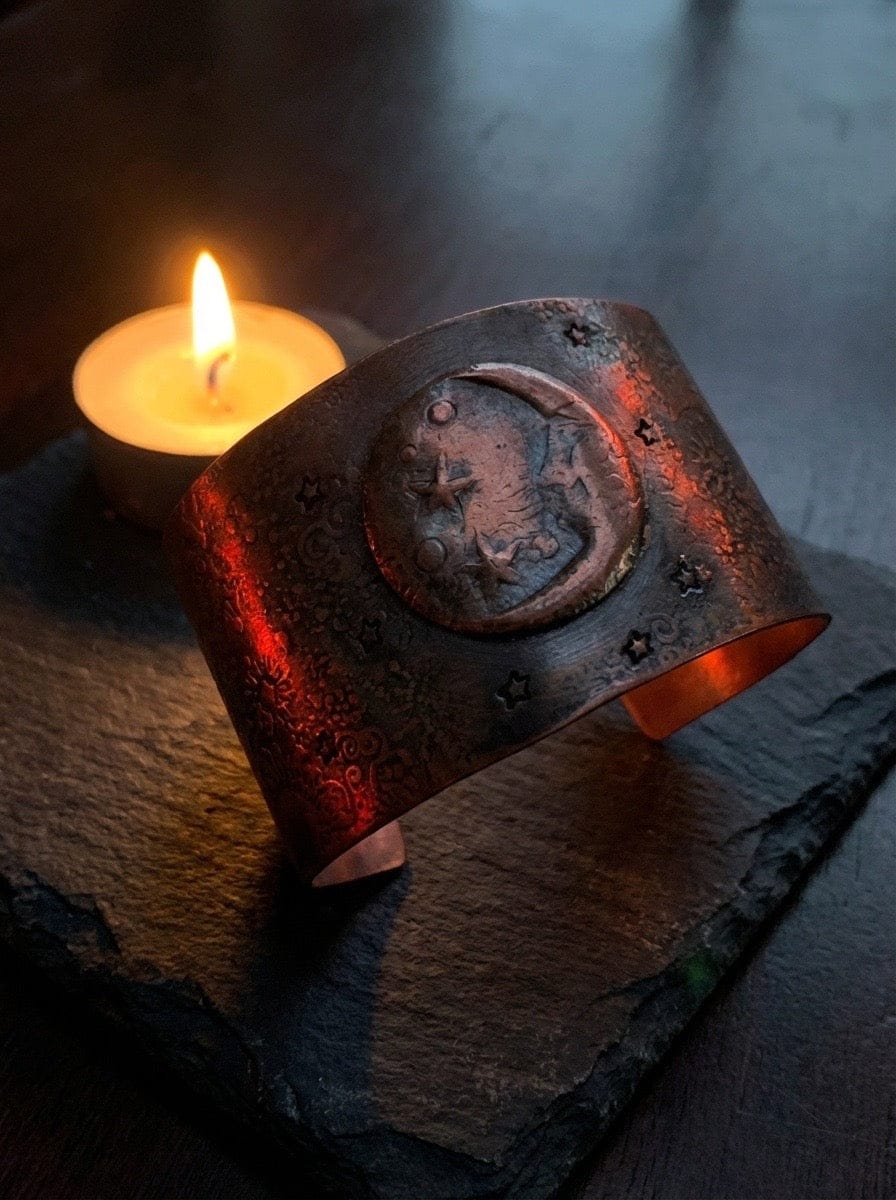 Moon Glo Copper Cuff with candle behind it
