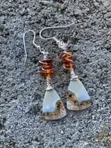 Mountain climb inspired earrings on stone background