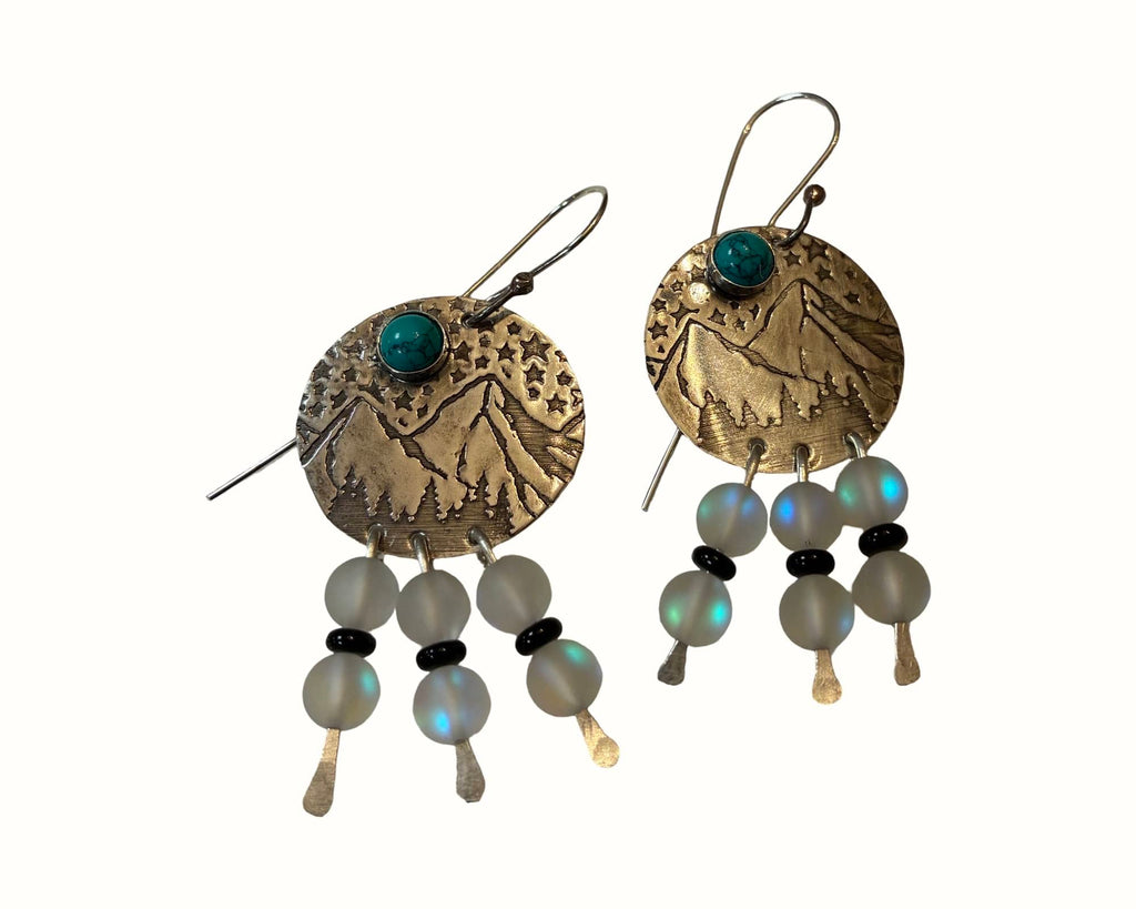 Mountain View handcrafted brass earrings featuring engraved mountain landscapes with genuine turquoise, aurora glass bead dangles, black onyx accents, and sterling silver ear wires.