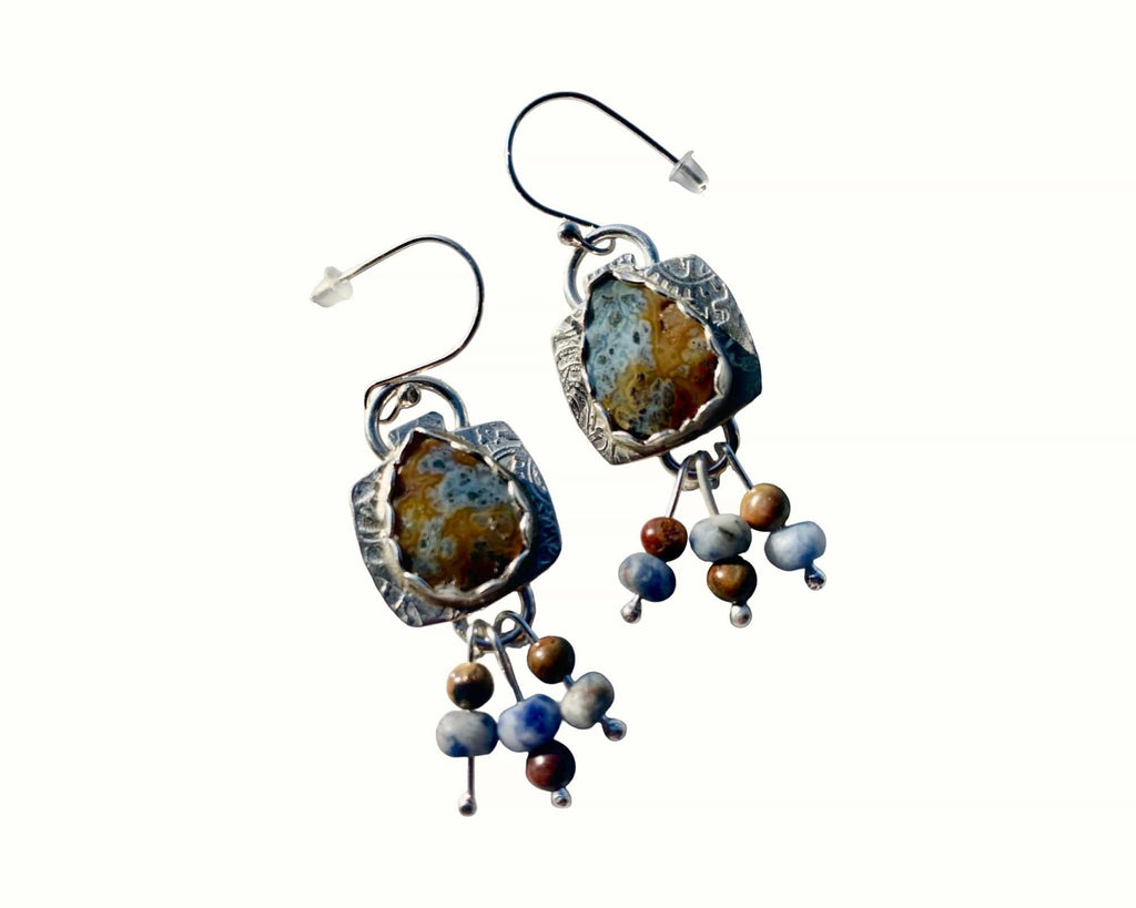 Earrings with natural stone and bead design on a white background