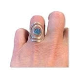 Silver swirl ring with blue gemstone