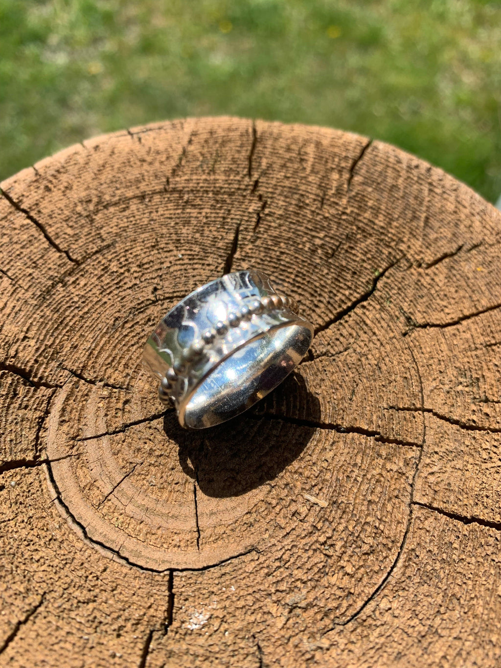 Silver spinner ring on wood