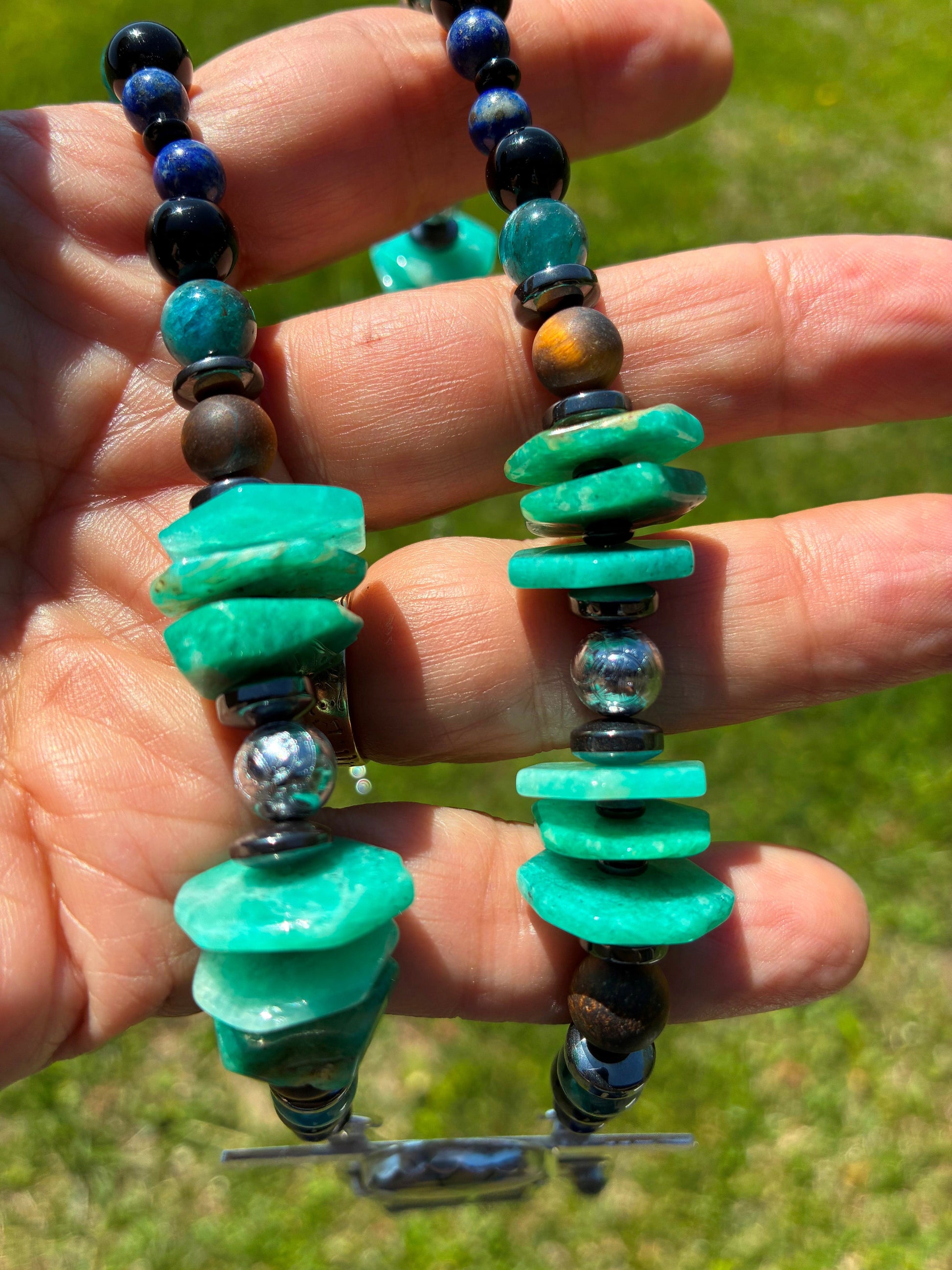 Close up of Meteorite beads on gemstone chain of pendant