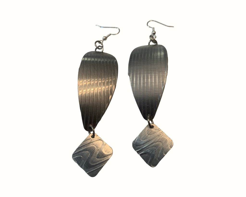 Pair of silver aluminum earrings on a white background