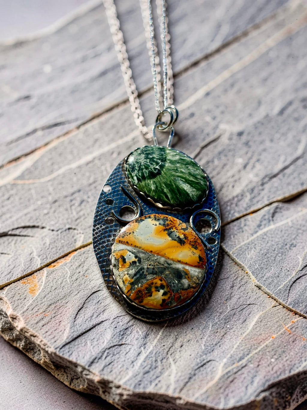 The Unfolding one-of-a-kind silver pendant by Christine Keller featuring green Seraphinite above golden Maligano Jasper in an original textured silver setting.