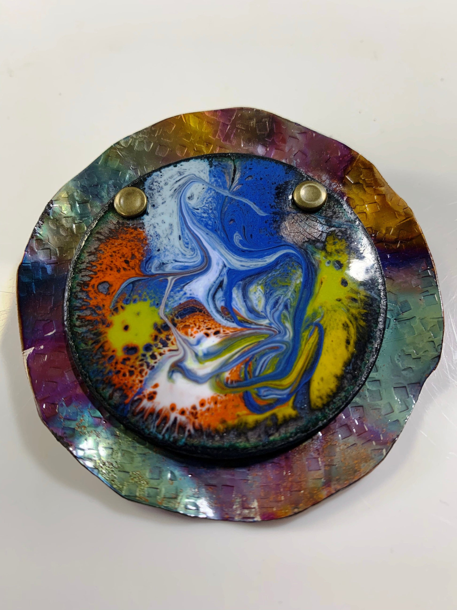 Vibrant and alive enamel art Brooch with swirling blue and orange design.